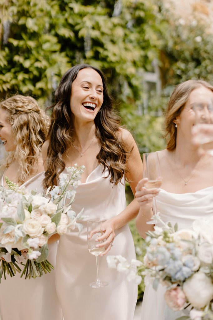 bridesmaid laughing in silk blush slip dress